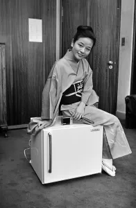 A woman wearing a Kimono sitting on a Japanese food freezer. 26th July 1965 A woman wearing a Kimono sitting on a Japanese food freezer. 26th July 1965