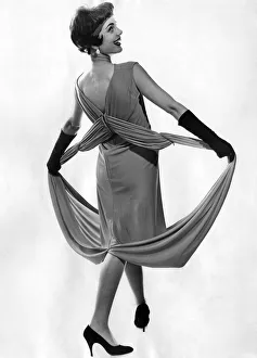 Woman wearing a long sleveless dress with black gloves and high heel shoes Woman wearing a long sleveless dress with black gloves and high heel shoes