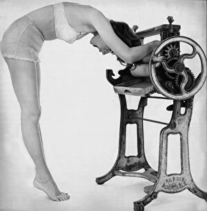 Images Dated 10th February 2005: A woman wearing underwear drying her through an old fashioned roller machine
