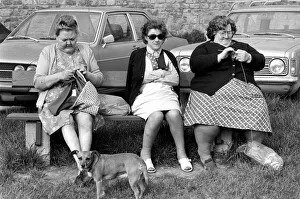 Three women with larger figures seen here knitting whilst their children play in a poorer Three women with larger figures seen here knitting whilst their children play in a poorer