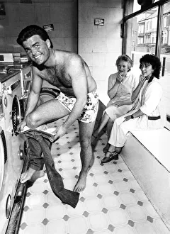 Women shoppers stop and stare as Tony Carlisle takes off a well known T Women shoppers stop and stare as Tony Carlisle takes off a well known T