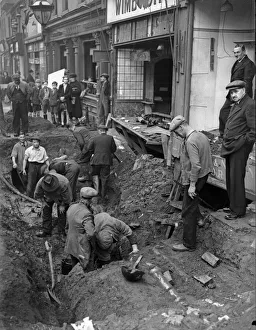 Workmen inspect a crater in central Birmingham following a raid on the city Workmen inspect a crater in central Birmingham following a raid on the city