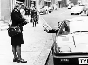 Writer Bryan Rimmer shows a traffic warden his sign Writer Bryan Rimmer shows a traffic warden his sign