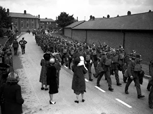 WW2 British Soldiers marching along road past well wisher WW2 British Soldiers marching along road past well wisher