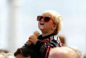 Two year old Craig Emmerson enjoys an ice cream whist watching an air display at Two year old Craig Emmerson enjoys an ice cream whist watching an air display at