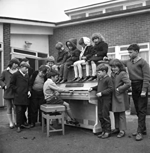 Eleven year old Martin Hawes entertains his school friends to a tune on the John Lennon Eleven year old Martin Hawes entertains his school friends to a tune on the John Lennon