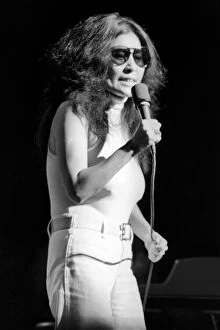 Images Dated 30th August 1972: Yoko Ono singing in a charity concert in New York with her husband John Lennon