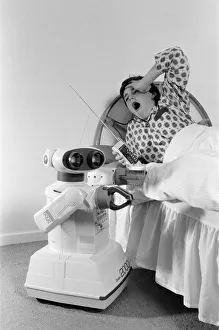 A young boy in bed being woken by an Omnibot 2000 toy robot. 21st October 1986 A young boy in bed being woken by an Omnibot 2000 toy robot. 21st October 1986