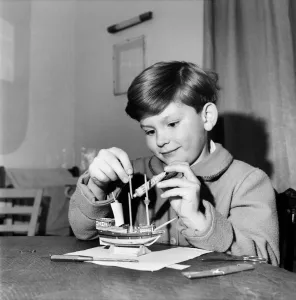 Young boy making a model replica of the HMS Victory, the ship of Lord Horatio Nelson Young boy making a model replica of the HMS Victory, the ship of Lord Horatio Nelson