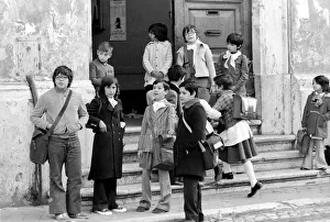 Young children on the steps of their school building in a poor suburb on the outskirts Young children on the steps of their school building in a poor suburb on the outskirts