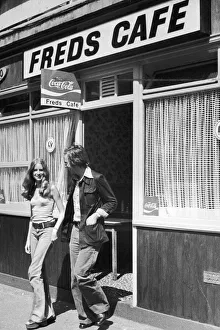 Young couple walking out of Fred's cafe ineast London after finishing their lunch Young couple walking out of Fred's cafe ineast London after finishing their lunch