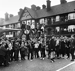Young football fans sits on top of the crossbar following the conclusion of the Eldon Young football fans sits on top of the crossbar following the conclusion of the Eldon