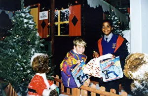 Young helpers, Smiley Crabbe, on the right, and Sean Behan pictured outside Santa' Young helpers, Smiley Crabbe, on the right, and Sean Behan pictured outside Santa'