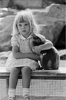 Young Kirsten Ogilvie with a baby penguin at the Cotswold WildLife Park in Oxfordshire Young Kirsten Ogilvie with a baby penguin at the Cotswold WildLife Park in Oxfordshire