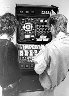 Images Dated 1st September 1983: Young people playing on a one armed bandit or electronic gaming machine in September 1983