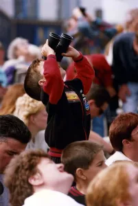 A young spectator looks through a pair of binoculars at an air display at the Sunderland A young spectator looks through a pair of binoculars at an air display at the Sunderland