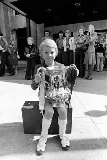 A young West Ham fan holding the FA cup trophy during the West Ham victory parade in A young West Ham fan holding the FA cup trophy during the West Ham victory parade in