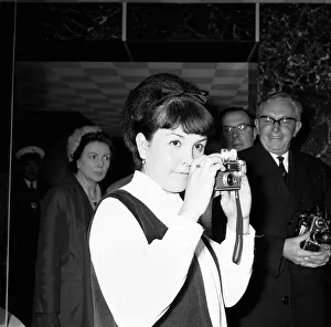 A young woman takes a photograph of Prime Minister Harold Wilson (1916 - 1995 A young woman takes a photograph of Prime Minister Harold Wilson (1916 - 1995