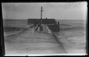 Children on Banjo Pier, East Looe, with stormy sea Children on Banjo Pier, East Looe, with stormy sea