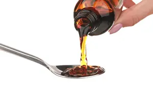 Cough Syrup Print in Spoon on White Background