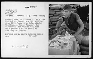 Print of a Marine eating during patrol in Vietnam, October 1969
