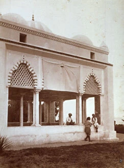 Tunis Collection: The arabic portico of a Moresco style building, in Tunis. There are three men in ethnic clothes