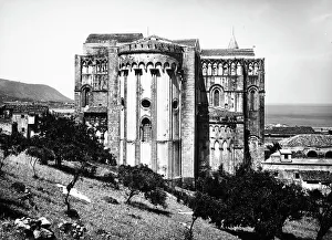 External view of the apse of the Cathedral of Cefal, province of Palermo. The coast is in the background