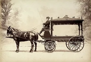 Hearse pull by horses led by a coachman