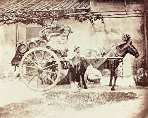 Horse Drawn Wagon Prints: A man posing next to a wagon wine