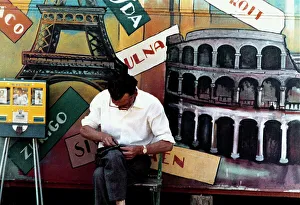 City View Photography Prints: Man sitting in front of a painted panel