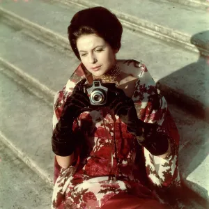 Model posing with a camera