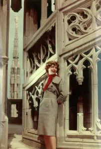 Model posing among the spiers of a building