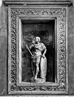 Niche with a rectangular frame decorated with spirals and acanthus-like leaves. Inside the niche is a full statue of the Duke Federico da Montefeltro dressed as a warrior. Work located on the large staircase of the Ducal Palace in Urbino