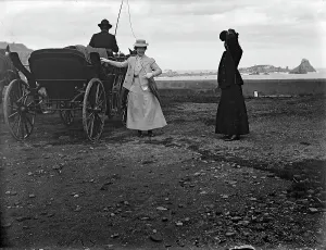 Pair of ladies photographed near a carriage on the terrace of Aci Castello