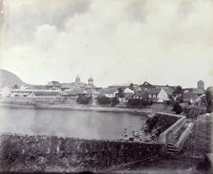 Panoramic view of Panama. In the foreground a stream, beyond which are a group of houses