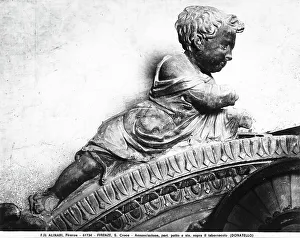 A putto on top of the tabernacle, detail of the Annunciation, high relief by Donatello, in the Basilica of Santa Croce, Florence, Tuscany