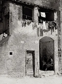 Civic Space Furniture Prints: Rustic building with laundry hanging