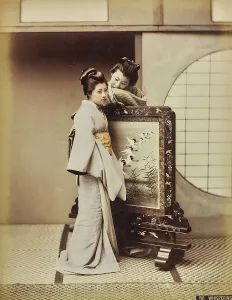 Young geisha beside a draft shield
