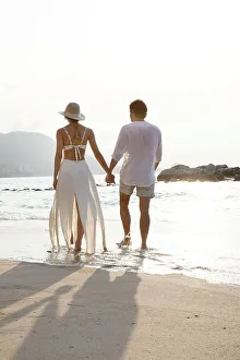 Couple Walking On Beach Prints: Couple walking along beach