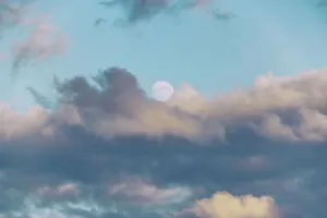 Cloudy Daytime Scene Prints: Moon surrounded by clouds