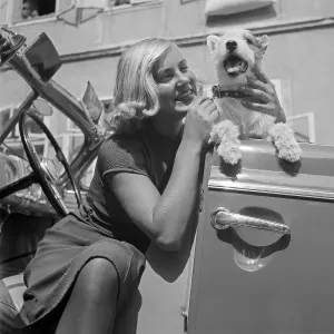 Freizeit Print: Young Woman and Fox Terrier Exiting Convertible, Austria 1930s