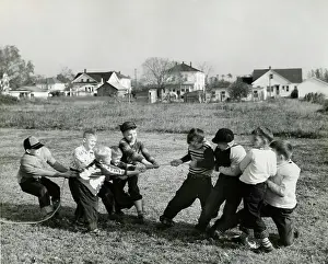 Retro Black And White Photography Prints: Boys pulling rope on field