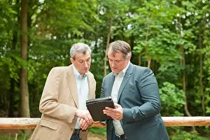 Images Dated 11th May 2012: Businessmen Print on Tablet Computer