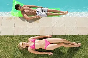 Poolside Relaxation Prints: Couple sunbathing at the pool