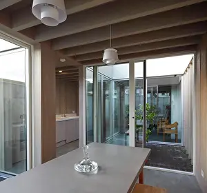 Prints of Dining space with view of interior courtyard. Ellis House, Ilford, United Kingdom. Architect: Buf Architects, 2019 October Prints: Dining space print with interior courtyard view, Ellis House, Ilford