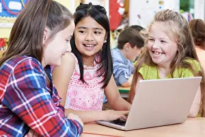 Prints of Group Of Elementary School Children Working Together In Computer Class February Prints: Elementary School Children Working Together Print
