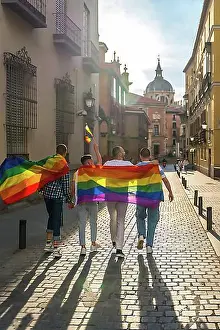 Urban Pride Celebration Prints: Man with his back facing the demonstration with the rainbow flags