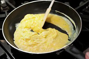 Frying Pan Cooking Prints: Preparing scrambled eggs in a pan