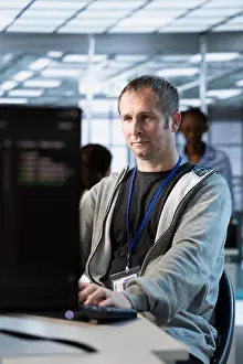 Data Backup Solutions Prints: IT professional optimizing data center gear for maximum efficiency and uptime