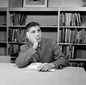 Prints of School boy reading in library July Prints: School boy reading in library Print